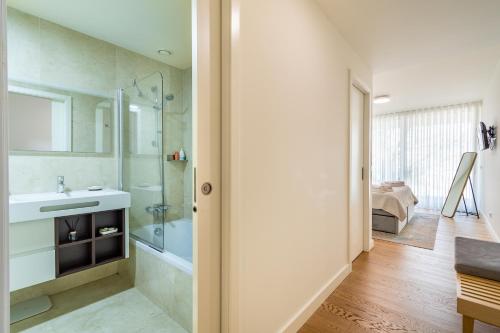 a bathroom with a sink and a shower and a tub at Douro Porto View in Vila Nova de Gaia