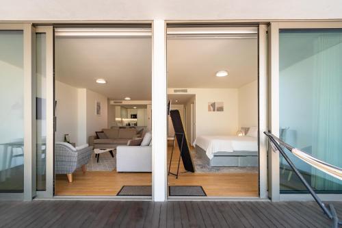 a room with sliding glass doors and a bedroom at Douro Porto View in Vila Nova de Gaia