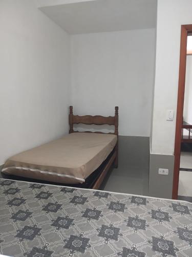 a bed in a room with at Aparts Lesther in Ubatuba