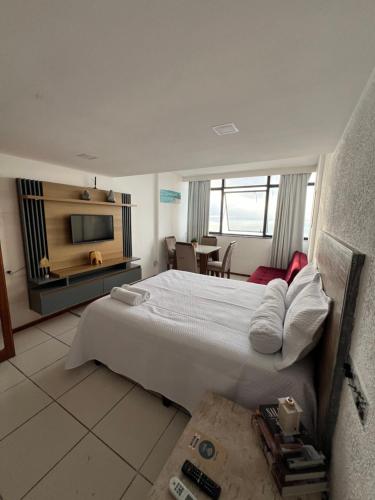 a hotel room with a bed and a television at Flat 308 - Vista Mar in Salvador