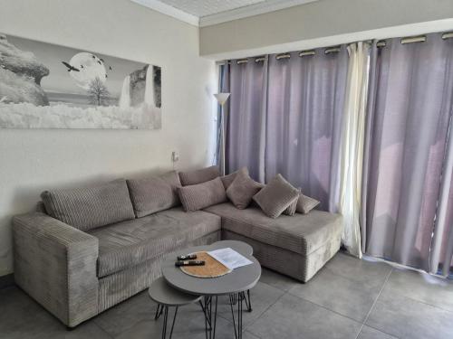 a living room with a couch and a table at Pearl island suite in Ashkelon