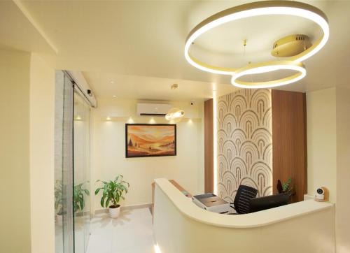 a lobby with a chair and a chandelier at Greens Venue in Chennai