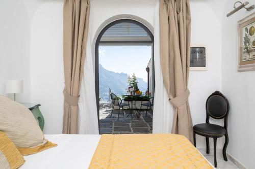a bedroom with a bed and a view of a table at Villa Amore Amalfi Coast in Ravello
