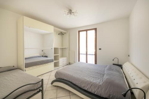 a bedroom with a bed and a large mirror at Alba sul Mare Apartment in Campofilone