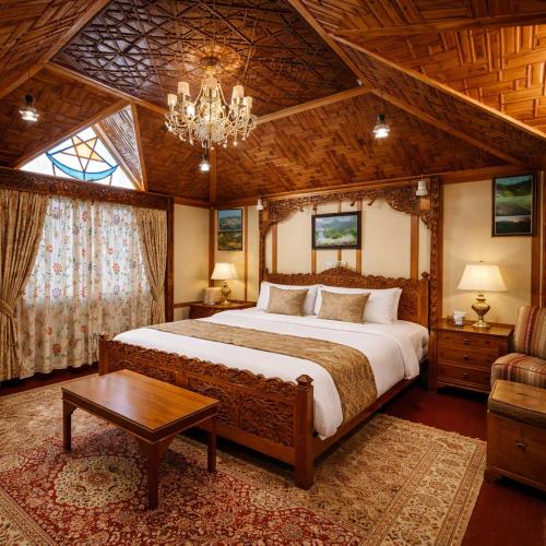 a bedroom with a large bed and a chandelier at Imperial Group of Houseboats in Srinagar