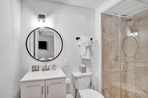 a bathroom with a shower and a toilet and a sink at Beachside Studio w Pool Access Steps from the Shore in Pompano Beach