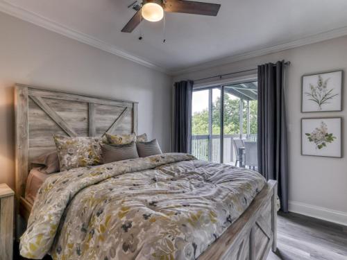 a bedroom with a large bed and a window at Tranquility Skies MTN View Sauna Jacuzzi MORE in Gatlinburg