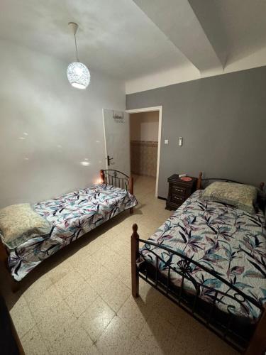 a bedroom with two beds in a room at Appartement T3 équipé à Biskra in Biskra