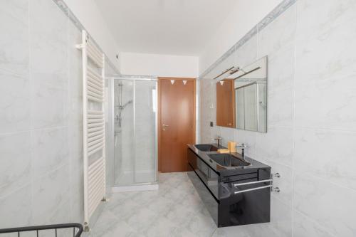 a bathroom with a sink and a shower at Alba sul Mare Apartment in Campofilone