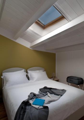 a bedroom with a bed with a book on it at Casa Majore in Chiaramonte Gulfi