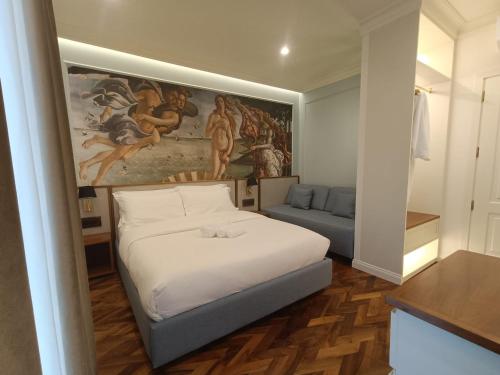a bedroom with a bed and a painting on the wall at Aria Domus in Lastra a Signa