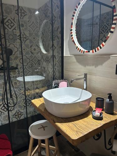 a bathroom with a large white bowl sink on a wooden table at Il melograno in Usini