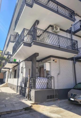 a building with balconies on the side of it at B&B Le Corti in Caserta