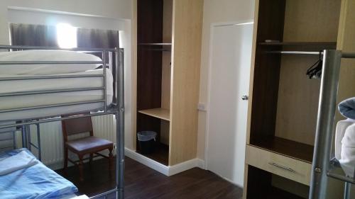 a bedroom with a bed and a dresser at Lynden Court Hotel in Bournemouth