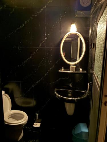 a bathroom with a toilet and a sink and a mirror at Mk Big boss otel in Erzurum
