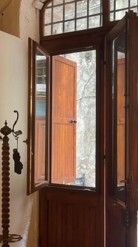 a wooden door with a window in a room at Casa "La Fonte" in Spoleto