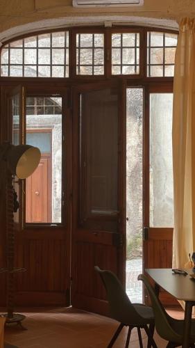a room with glass doors and a table and chairs at Casa "La Fonte" in Spoleto