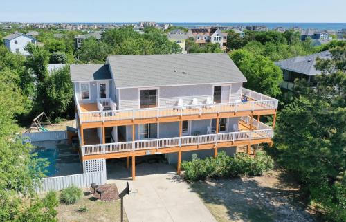 an aerial view of a house with a deck at Casa Bella - Duck, Bayberry Bluffs, Ocean View, 500 Yds to Beach, Pool, Hot Tub, Playset, Pets OK in Duck