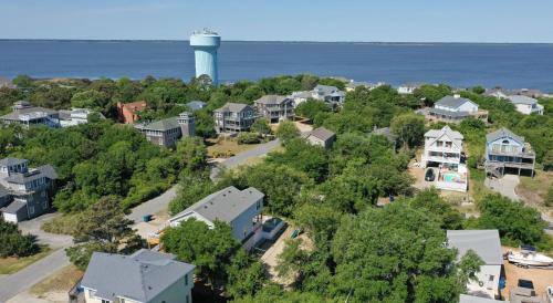 an aerial view of a residential neighborhood with a lighthouse at Casa Bella - Duck, Bayberry Bluffs, Ocean View, 500 Yds to Beach, Pool, Hot Tub, Playset, Pets OK in Duck