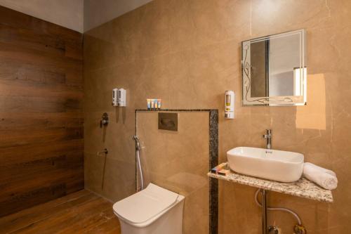 a bathroom with a sink and a toilet at Ellara Homes in Udaipur