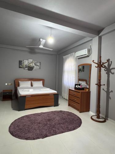 a bedroom with a bed and a mirror and a rug at The Surf Loft in Weligama