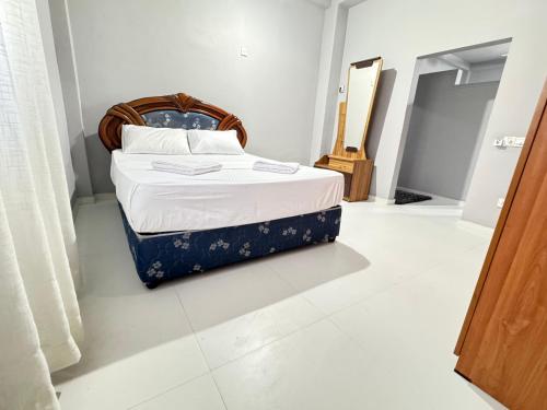 a bedroom with a bed and a mirror at The Surf Loft in Weligama