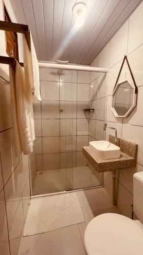 a bathroom with a shower and a toilet and a sink at Villa Mar - Baia Formosa in Baía Formosa