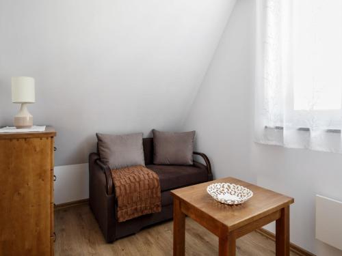 a living room with a couch and a table at TatryTop Narciarski Jurgów in Jurgów