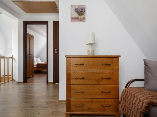 a bedroom with a dresser with a lamp on it at TatryTop Narciarski Jurgów in Jurgów