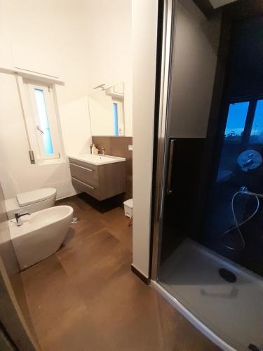 a bathroom with a toilet and a sink and a shower at casamiacasatua in Ronciglione
