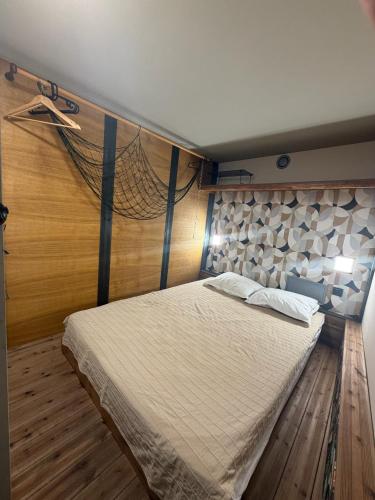 a bedroom with a bed with a net on the wall at Swed Cab Embassy HoStel in Varna City