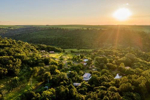 an aerial view of a village in the forest at sunset at Hotel Fazenda Vale Alvorada in Toledo
