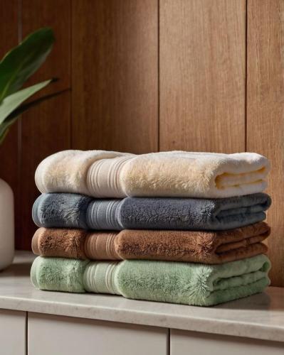 a stack of towels sitting on a table at Beksultan guest house in Epkin