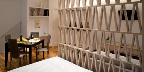 a dining room with a table and a partitioned wall at Casa Majore in Chiaramonte Gulfi