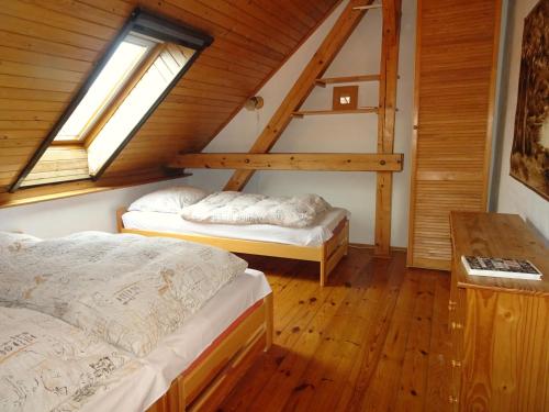 a bedroom with two beds in a attic at chalupa U Hovorků s bazénem - u pískoven Vlkov in Veselí nad Lužnicí