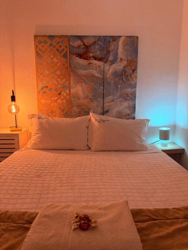 a bedroom with a bed with a flower on it at Zambujeira Lounge in Zambujeira do Mar