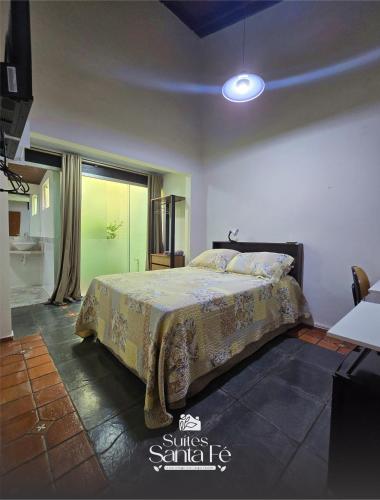 a bedroom with a bed in a room at SUITES SANTA FÉcg A5 in Campo Grande