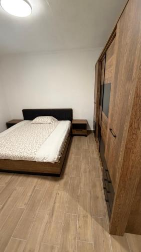 a bedroom with a bed and a large wooden cabinet at Casa Oliva in Orahovo