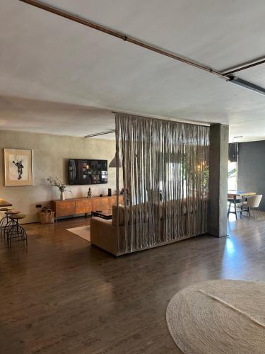 a living room with a couch and a table at LOFT "EL PARQUE" in Níjar
