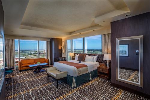 a hotel room with a bed and a large window at Choctaw Casino & Resort Durant, a Wyndham Grand Hotel in Durant