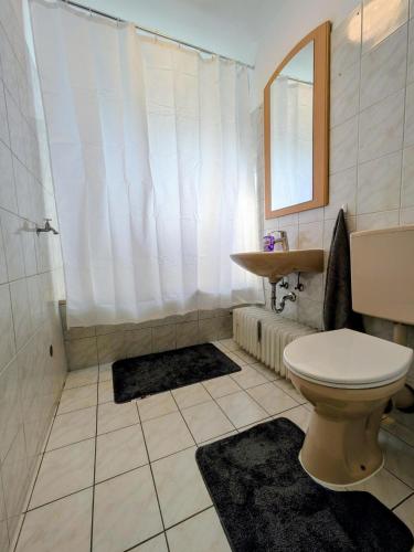 a bathroom with a toilet and a sink at interaktiv Appartements in Heiligenhaus - Herzogstrasse in Heiligenhaus