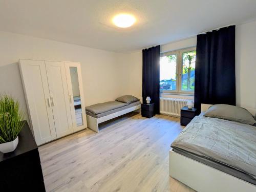 a bedroom with two beds and a window at interaktiv Appartements in Heiligenhaus - Herzogstrasse in Heiligenhaus