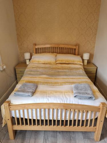 a bedroom with a bed with two towels on it at Bridie's Cottage in Mullagh