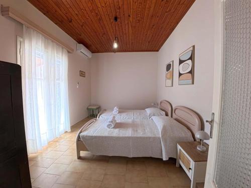 a bedroom with a bed and a wooden ceiling at The Homey in Sidari