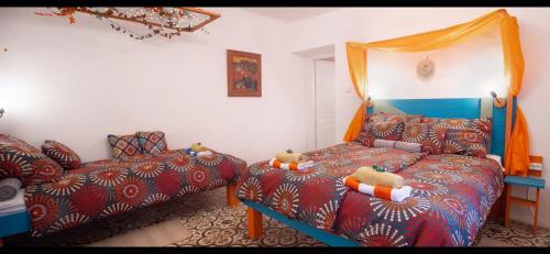 a bedroom with a bed and a couch with teddy bears on it at Jelkő Ház in Terpes