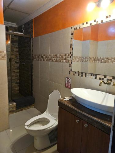 a bathroom with a toilet and a sink at Apartaments Malecon 2000 in Guayaquil