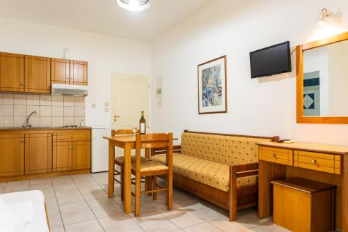 a kitchen with a couch and a table in a room at Ionion Hotel in Syvota