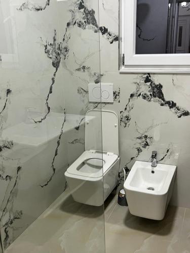 a bathroom with a toilet and a sink at Villa Cozy in Laknas