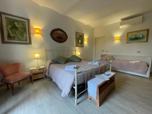 a bedroom with a bed and a chair at Historic family house in Montefiascone
