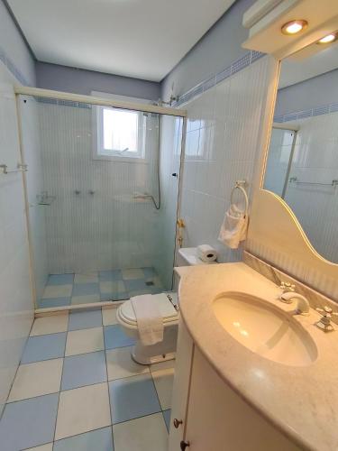 a bathroom with a toilet and a sink and a shower at Centro, Rua Coberta, perto de tudo! in Gramado